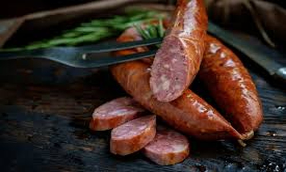 Why are grilled German sausages popular during social meals?